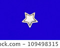 Christmas five pointed golden star on blue background. Christmas decoration. 109498315