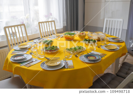 Easter family celebration. Traditional Polish dishes on a wooden table with yellow tablecloth Easter family celebration. Traditional Polish dishes on a wooden table with yellow tablecloth 109498718