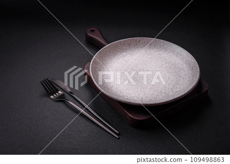Empty round ceramic plate as an item of kitchen utensils Empty round ceramic plate as an item of kitchen utensils 109498863