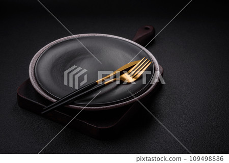 Empty round ceramic plate as an item of kitchen utensils Empty round ceramic plate as an item of kitchen utensils 109498886