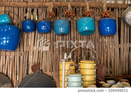 Food containers and pots in the walls of a traditional Asian kitchen. 109499033