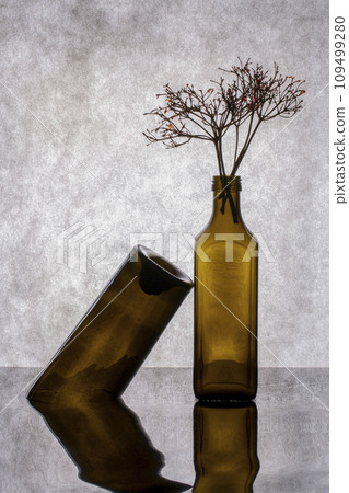Still life with colored glass bottles and plant twigs Still life with colored glass bottles and plant twigs 109499280