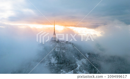 Jested mountain with modern hotel and TV transmitter on the top, Liberec, Czech Republic. Building in clouds. Aerial view from drone. 109499617