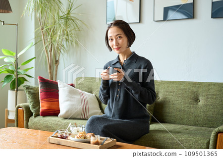 A woman relaxing on the sofa A woman relaxing on the sofa 109501365
