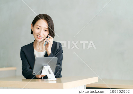 Staff in suits making phone calls 109502992