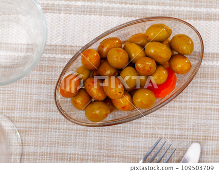 Green Spanish pitted olives in spices with carrots in bowl Green Spanish pitted olives in spices with carrots in bowl 109503709
