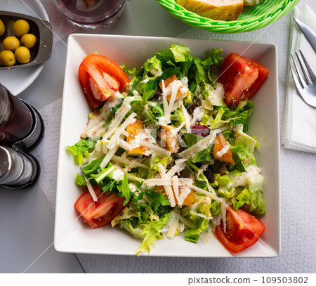 Variation of Caesar salad with chicken, lettuce mix and crackers Variation of Caesar salad with chicken, lettuce mix and crackers 109503802