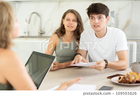 Married couple of clients listen attentively and intently to woman of seller Married couple of clients listen attentively and intently to woman of seller 109503826