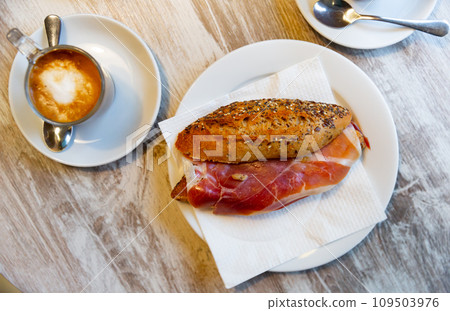 Sandwiches bocadillo from fresh baguette filled with sliced ham. Spanish food 109503976