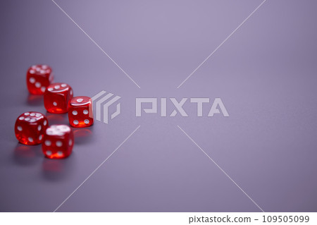 Red dices on grey background. Copy space. 109505099