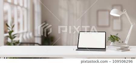 Workspace with a white-screen digital tablet mockup on a white table in a modern white room. Workspace with a white-screen digital tablet mockup on a white table in a modern white room. 109506296