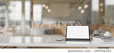 A white-screen digital tablet mockup on a white tabletop in a modern beautiful coffee shop. 109506303