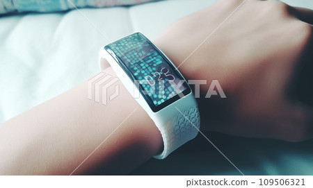 A woman's hand looking at data on a smartwatch/wearable device/gadget 109506321