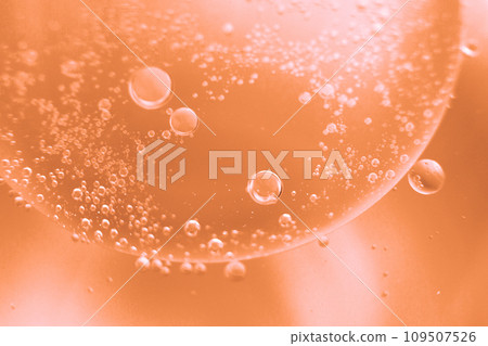 abstract light Peach Fuzz background with oil circles . bubbles of water close up abstract light Peach Fuzz background with oil circles . bubbles of water close up 109507526
