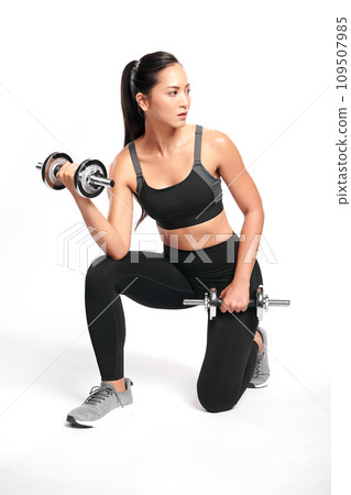 an asian woman is working out with dumbbells wearing the sport exercise suit with white background, an asian woman is working out with dumbbells wearing the sport exercise suit with white background, 109507985