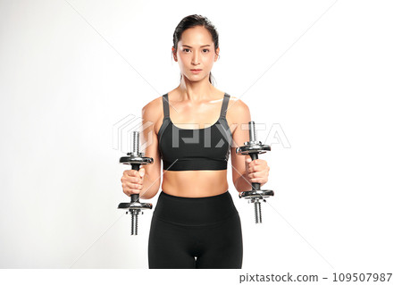 an asian woman is working out with dumbbells wearing the sport exercise suit with white background, an asian woman is working out with dumbbells wearing the sport exercise suit with white background, 109507987