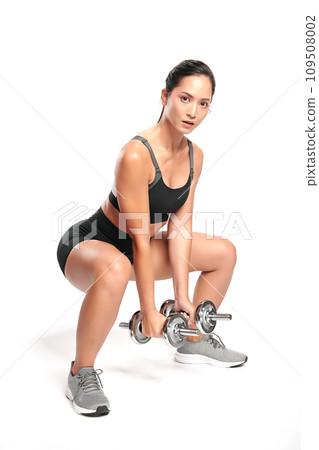 an asian woman is working out with dumbbells wearing the sport exercise suit with white background, 109508002