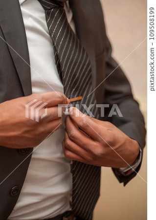 The Final Touch: Man Adjusting Tie Clip The Final Touch: Man Adjusting Tie Clip 109508199