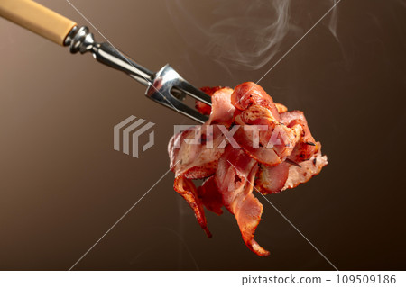 Roasted bacon on a fork. Roasted bacon on a fork. 109509186
