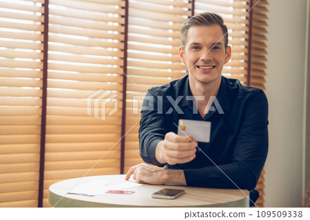 Young man using laptop with credit card for internet banking. Unveiling 109509338