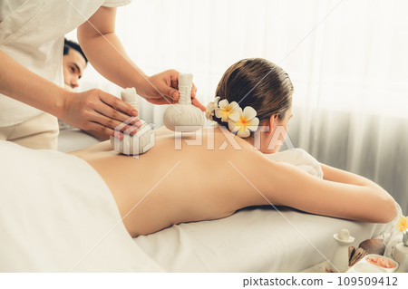 Hot herbal ball spa massage body treatment at day spa . Quiescent 109509412