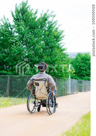 young man in a wheelchair young man in a wheelchair 109509509