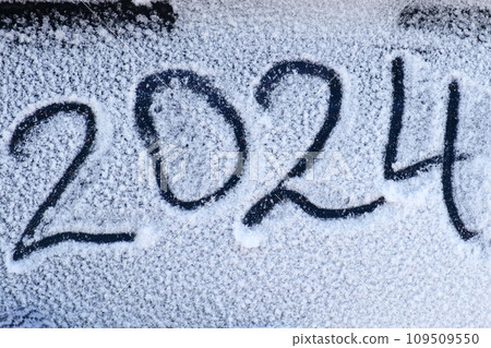 2024 New Year holiday text drawing on snow. Handwriting inscription 2024 date on white surface of winter snow. New Year and Christmas concept. Hand in knitted glove writing on a snow surface 2024 date 2024 New Year holiday text drawing on snow. Handwriting inscription 2024 date on white surface of winter snow. New Year and Christmas concept. Hand in knitted glove writing on a snow surface 2024 date 109509550
