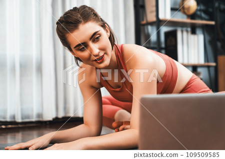 Flexible and dexterity woman in sportswear doing reverse gaiety yoga position 109509585