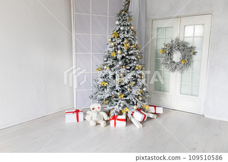 Christmas tree for new year with gifts in white grey interior 109510586