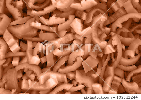 Texture slices of chopped green bell pepper. Peach fuzz is color of year 2024 tinted image 109512244