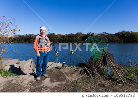 A man enjoying fishing in the river A man enjoying fishing in the river 109512788