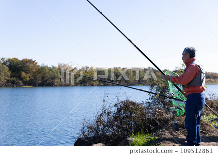 A man enjoying fishing in the river A man enjoying fishing in the river 109512861