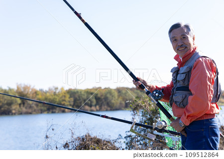 A man enjoying fishing in the river A man enjoying fishing in the river 109512864