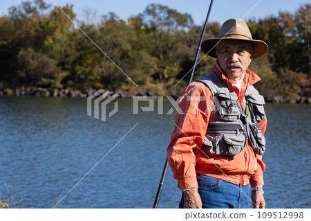 A man enjoying fishing in the river A man enjoying fishing in the river 109512998