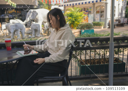 digital nomad concept asian freelancer woman use laptop to work at outdoor of coffeeshop digital nomad concept asian freelancer woman use laptop to work at outdoor of coffeeshop 109513109