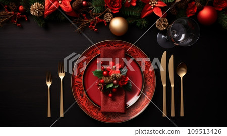 Christmas table setting with red and gold cutlery on black wooden background 109513426