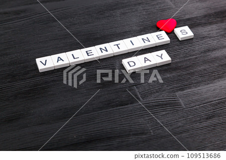 inscription Valentines day on a black wooden background inscription Valentines day on a black wooden background 109513686
