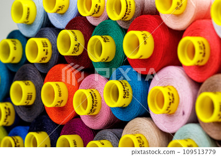 set of multi-colored spools of thread for sewing 109513779