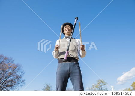Juggler man using devil stick Juggler man using devil stick 109514598