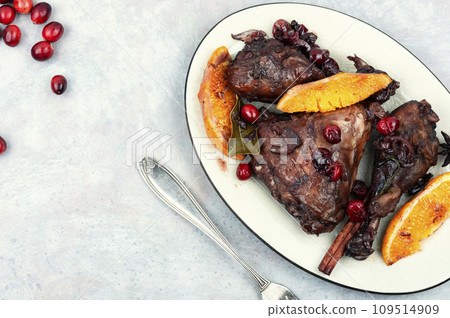 Baked chicken legs with orange and berries. Baked chicken legs with orange and berries. 109514909