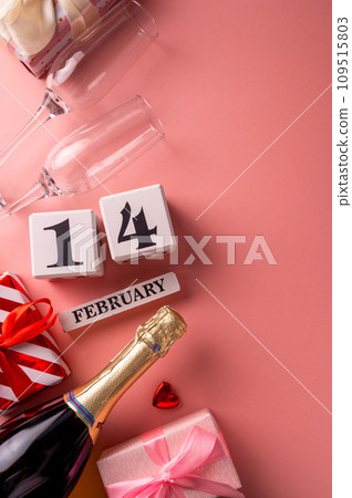 14 February Valentine's Day pink background, gift boxes, champagne, drinking glasses 109515803