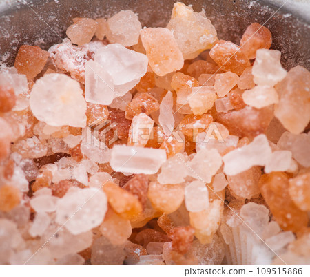 Himalayan pink salt in a spoon on a salt background close-up. Top view 109515886
