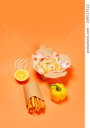 Yellow sweet pepper, mandarin and carrot against orange background. Organic products and healthy food Yellow sweet pepper, mandarin and carrot against orange background. Organic products and healthy food 109517522