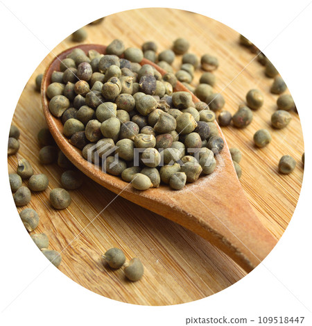Dried okra seeds in wooden spoon, on bamboo cutting board 109518447