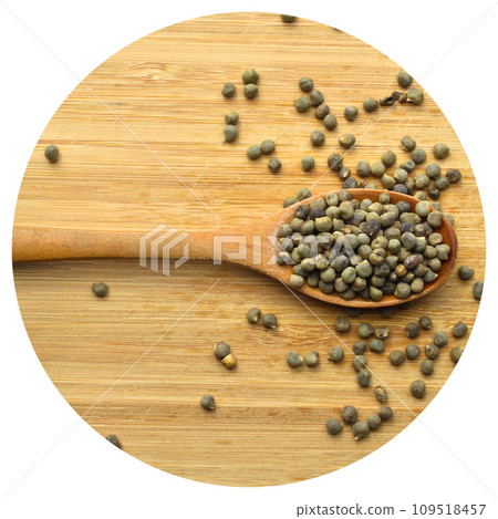 Dried okra seeds in wooden spoon, on bamboo cutting board Dried okra seeds in wooden spoon, on bamboo cutting board 109518457