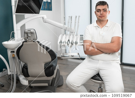 A dental professional with extensive experience is ready to take responsibility for the health of patients in a medical center. A dentist sits in a chair in a treatment room 109519067