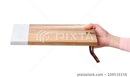 Female hand holding a rectangular empty kitchen board Female hand holding a rectangular empty kitchen board 109519158