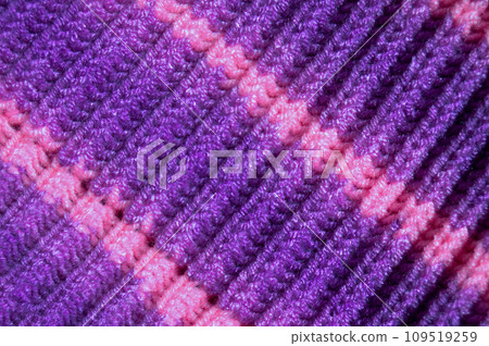 Handmade knitted fabric purple and pink wool background texture Handmade knitted fabric purple and pink wool background texture 109519259