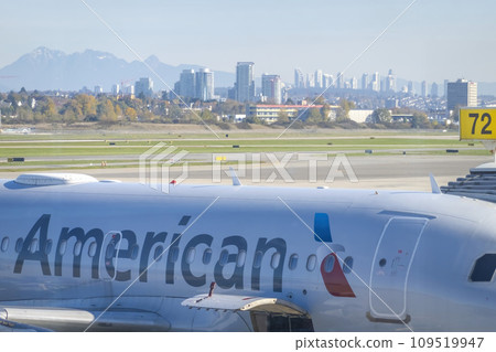 Vancouver, British Columbia, Canada, Nov. 16, 2023. An American Airlines aircraft at the Vancouver International airport, set against the backdrop of Vancouver city. 109519947