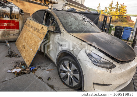 Calgary, Alberta, Canada. Oct 10, 2023. An electric Tesla car with fire damage in from a front house garage. 109519955